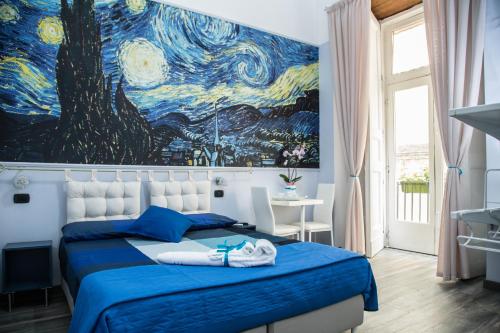 a bedroom with a blue bed with a painting on the wall at Art in B&B in Salerno