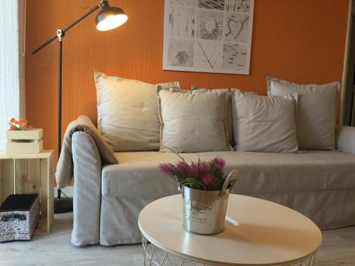 a living room with a couch and a table at Beach Houses in Costa da Caparica