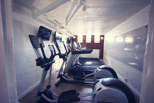 a gym with a row of exercise bikes in a room at Best Western Hotel Arctic Eden in Kiruna