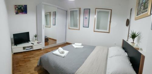 a bedroom with a large bed and a tv at Anamarija apartment in Korčula