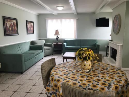 a living room with a table with flowers on it at Mallard Apartments in Ocean City