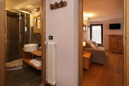 a bathroom with a shower and a sink in a room at Appartamenti Genevris in Sauze dʼOulx