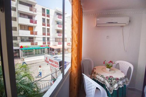 a balcony with a table and a view of a street at El Velero Apartamentos By DANP in Santa Marta
