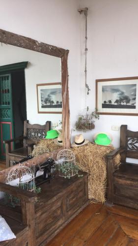 a room with a large mirror and hay on the floor at Finca Campestre La Adelita B&B in Salento