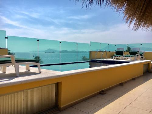 a balcony with a view of a swimming pool at Andressa Mia Apartments in Manzanillo