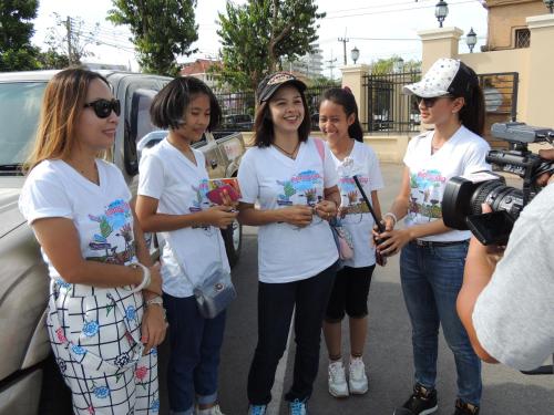 a group of young women standing next to a camera at ฺBaan Rai Ing Doi in Chaiyaphum