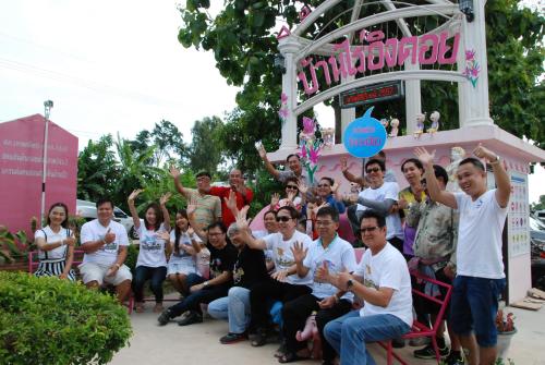 a group of people posing for a picture in front of a building at ฺBaan Rai Ing Doi in Chaiyaphum
