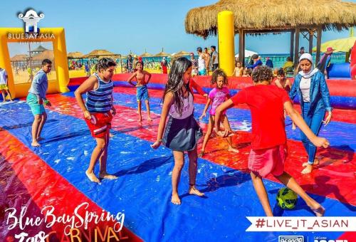 a group of people playing in a water park at Chalet in Bluebay Asia Resort Ain Sokhna in Ain Sokhna