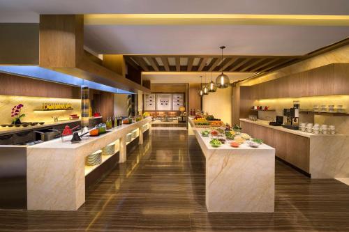 a restaurant with a buffet line with food at Hyatt Regency Dubai Creek Heights in Dubai
