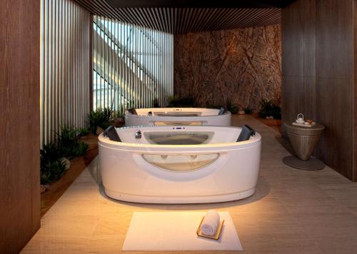 a bathroom with a white toilet in a room at Andaz Capital Gate Abu Dhabi, By Hyatt in Abu Dhabi