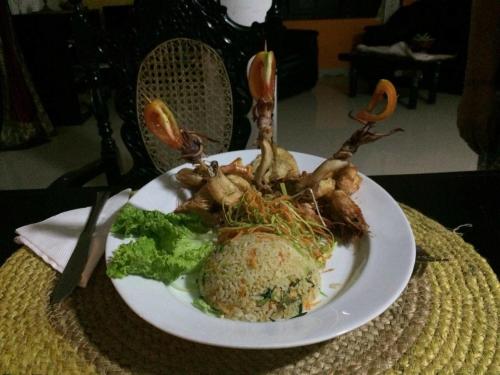 a plate of food with broccoli on a table at Residence Jasmine in Aluthgama