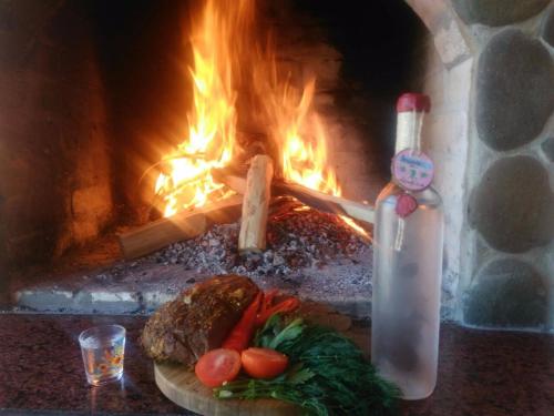 a plate of food in front of a fireplace at Bilovoddya Hotel in Sil'