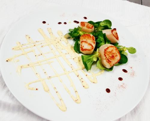 a white plate with a salad with scallops on it at Belvedere in Stresa