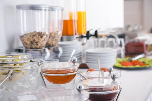 a kitchen counter with bowls and plates of food at Hotel Sunshine in Kamari