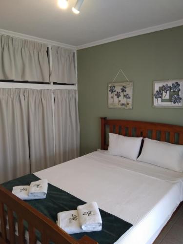 a bedroom with a large bed with two towels on it at Family-Elia in Paralia Dionysiou