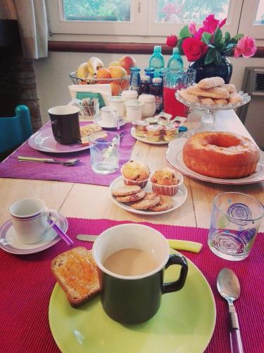 a table topped with plates of food and a cup of coffee at B&B Salighes in Ozieri