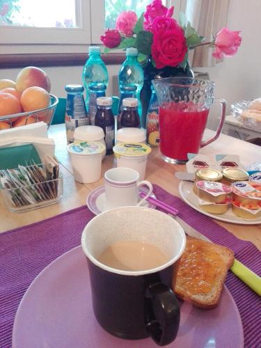 a table topped with a cup of coffee and toast at B&B Salighes in Ozieri