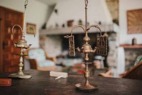 two metal candlesticks on top of a wooden table at Casa Firmo in Quintana