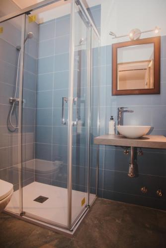 a bathroom with a glass shower and a sink at Casa Firmo in Quintana