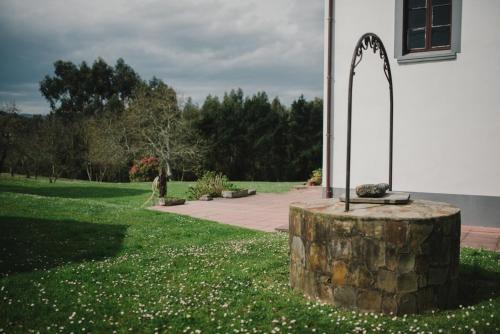 a church with a tree stump next to a building at Casa Firmo in Quintana