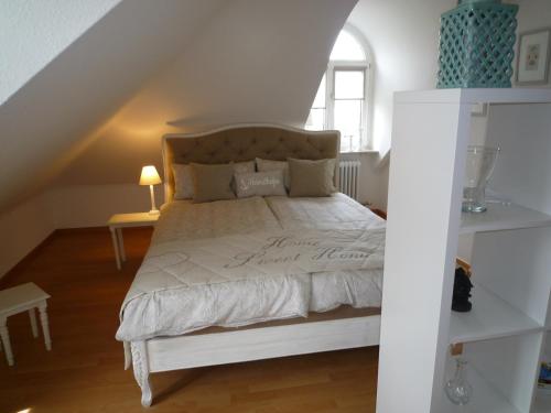 a bedroom with a white bed in a attic at Maisonette am Belchen in Bad Krozingen