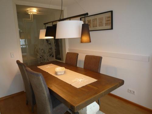 a dining room table with chairs and a candle on it at Maisonette am Belchen in Bad Krozingen