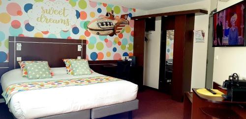 a bedroom with a bed and a wall with a tiger on it at Logis Boutique Hotel Novalis in Gradignan