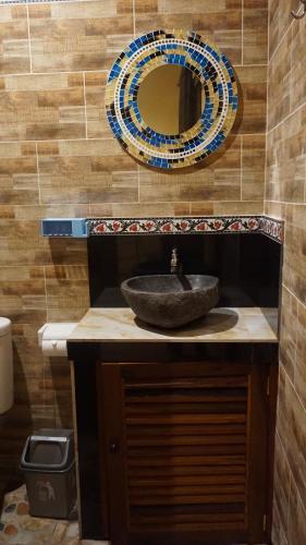 a bathroom with a sink and a mirror at Bima Sakti Homestay Echo Beach Canggu in Canggu