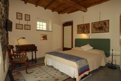 a bedroom with a bed and a table and a piano at Villa Paggi Country House in Carasco