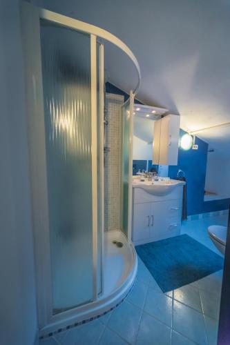 a bathroom with a shower and a sink at Villa Buzzi in Besozzo