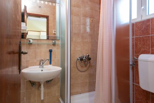 a bathroom with a sink and a shower at Holiday Resort Balota in Viganj