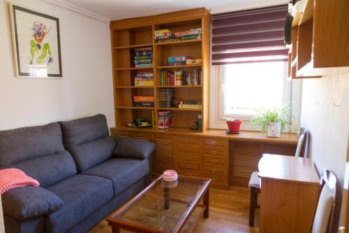 a living room with a blue couch and a table at Apartamento Garcilaso de la Vega in Cuenca