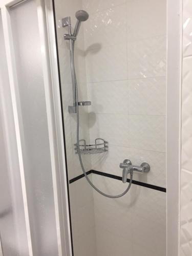 a shower in a bathroom with a glass door at Polyana Apart in Polyana