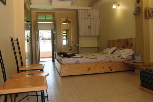 a bedroom with a bed and a table and chairs at Sai Homestay in Malvan