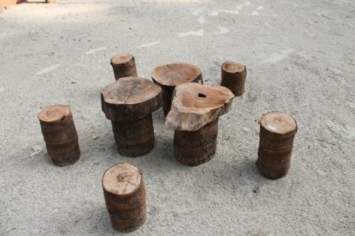 a group of wood stumps sitting on the ground at Sai Homestay in Malvan