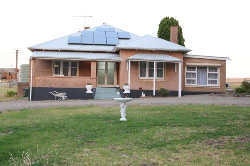 a house with a birdbath in front of it at Pink Gums Farmstay in Currency Creek