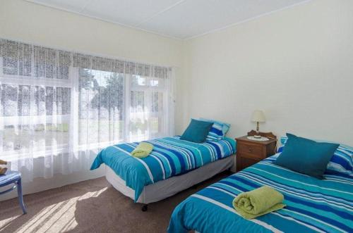 a bedroom with two beds and a window at Pink Gums Farmstay in Currency Creek