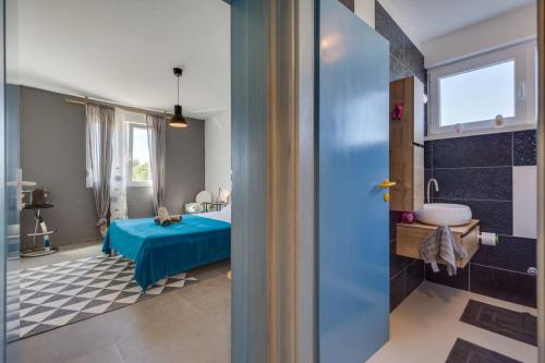 a bathroom with a blue bed and a sink at Apartment Marija in Petrcane