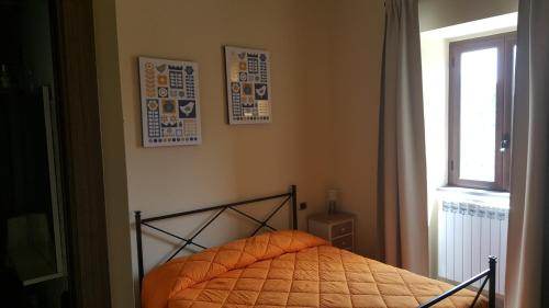 a small bed in a bedroom with a window at Mama Lina in Patti