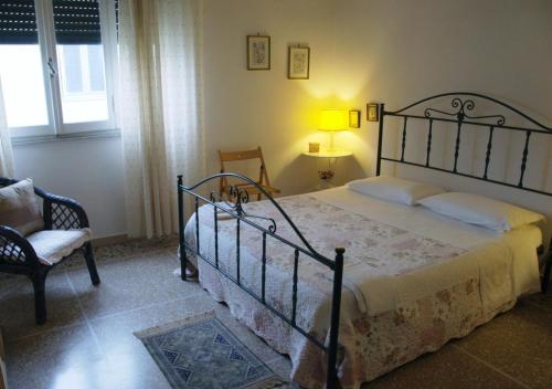 ピサにあるLa Coccinella Guest House Self Check-inのベッドルーム(大型ベッド1台、椅子付)