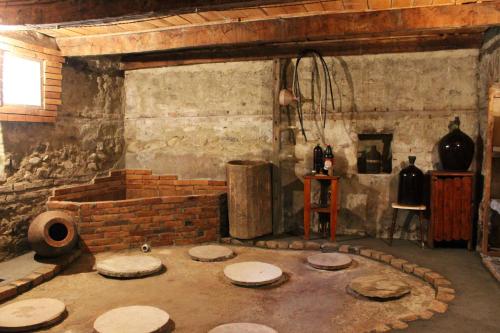 a room with a brick wall and a room with a table at GreenGate in Gurjaani