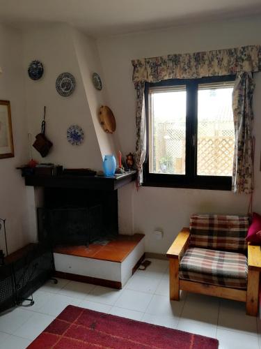 a living room with a couch and a window at La Lantana Nuova in Flumini di Quartu