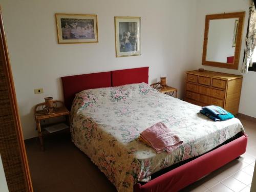 a small bedroom with a bed and a dresser at La Lantana Nuova in Flumini di Quartu