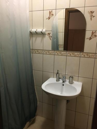 a bathroom with a sink and a mirror at Hotel Kardinal in Vinnytsya