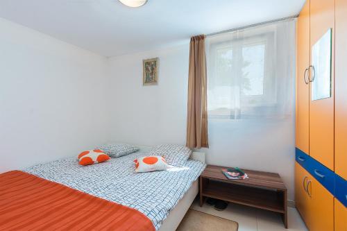 a bedroom with a bed with two pillows on it at Apartments Salak in Pula