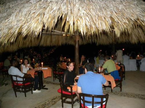 a group of people sitting at tables in a restaurant at Hotel Bahía de la Luna in Arroyo Cruz