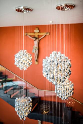 three chandeliers hanging from the ceiling in a room at Hotel Gartner in Tirolo