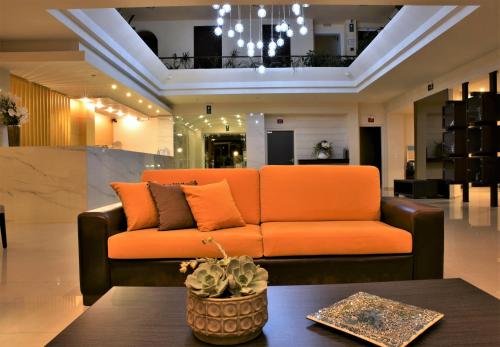 a living room with a couch and a coffee table at Theo Hotel in Agia Marina Nea Kydonias