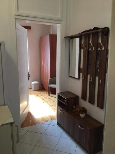 a room with a door open to a room with a mirror at S&I room in Kotor