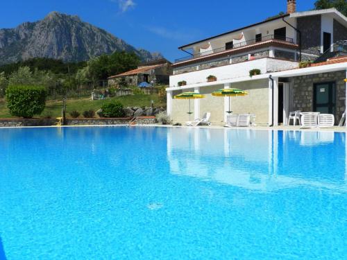 a large blue swimming pool in front of a house at Bel Tempio in San Giovanni a Piro